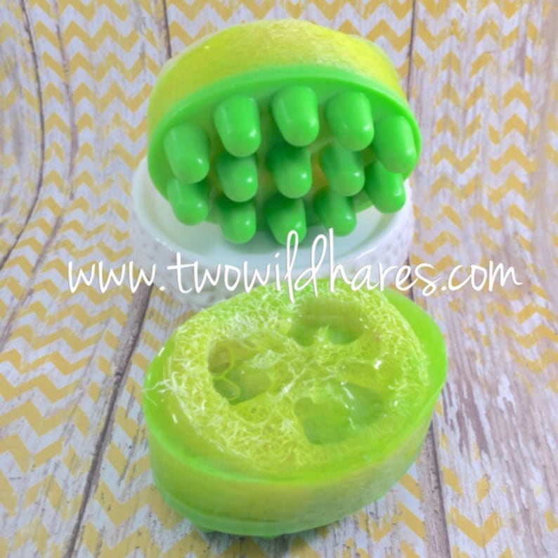 May include: Two green and yellow soap bars. One bar has a textured surface and the other has a bumpy surface with green nubs.