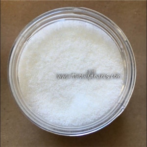 May include: A clear glass jar filled with white sugar crystals.