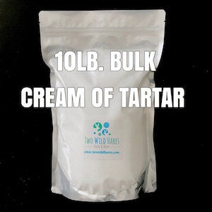 May include: A white resealable bag with a label that says "10LB. BULK CREAM OF TARTAR" and a logo for "TWO WILD HARES BATH & BODY" with the website address "www.twowildhares.com".