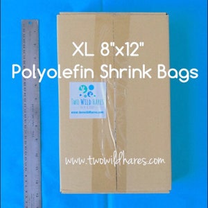 May include: A brown cardboard box with a white label that says "XL 8"x12" Polyolefin Shrink Bags" and a smaller label with the text "TWO WILD HARES" and the website address "www.twowildhares.com".