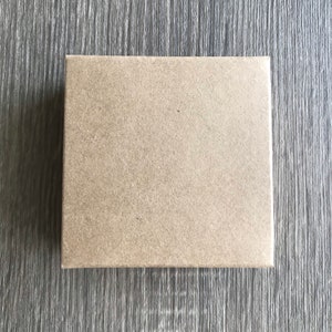 May include: A plain brown cardboard box with a slightly textured surface.