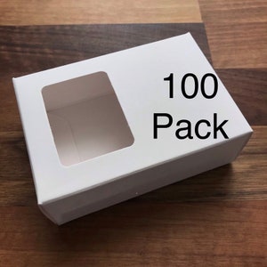 May include: A white cardboard box with a window cut out. The box has the text "100 Pack" printed on it.