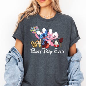 A woman wearing a gray t-shirt with a Disney-themed graphic and text, including characters from the Disney movie Lilo & Stitch.