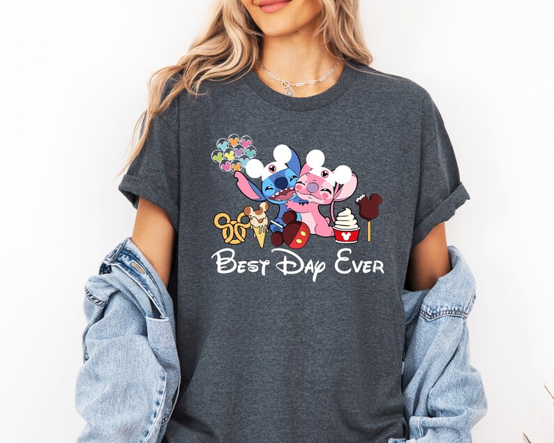 A woman wearing a gray t-shirt with a Disney-themed graphic and text, including characters from the Disney movie Lilo & Stitch.