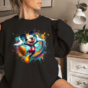a woman wearing a black mickey mouse shirt