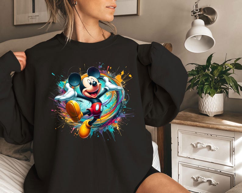 a woman wearing a black mickey mouse shirt