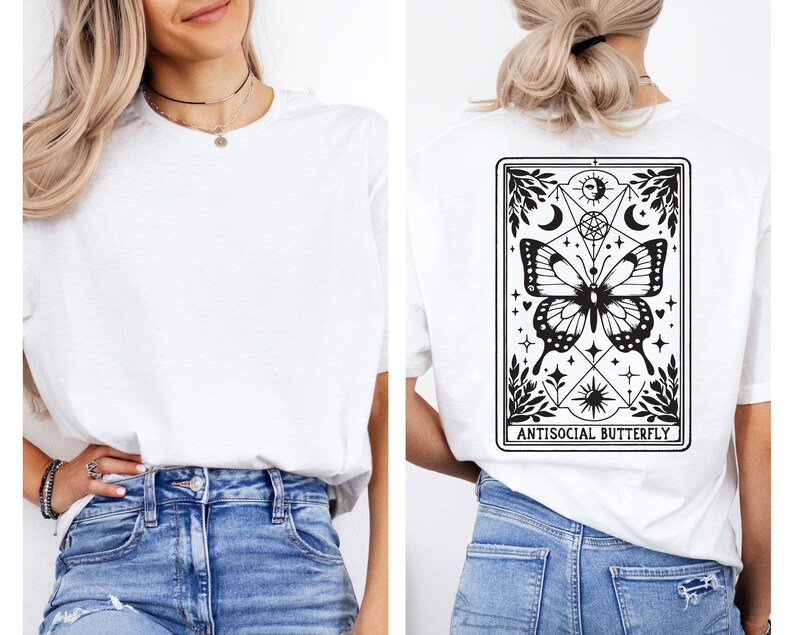 A woman wearing a white t-shirt with a graphic design on the back, featuring a butterfly and various symbols.