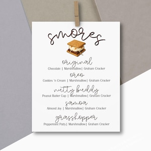 May include: A white card with the word "smores" in a script font, featuring a graphic of a s'more. Below, it lists s'more flavors: Original, Oreo, Nutty Buddy, Samoa, and Grasshopper, with their ingredients.