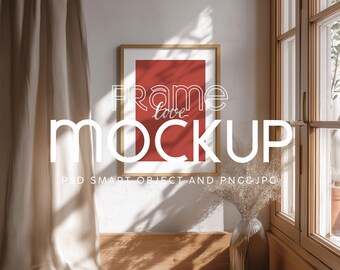 May include: A framed art mockup with a red background and the words "Frame love Mockup" in white. The frame is hanging on a white wall next to a window. The image includes a vase with dried plants.