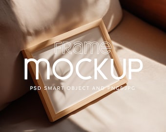 May include: A square wooden frame mockup with the text "Frame Mockup" in white. The frame is resting on a beige surface, with shadows cast across it. The text "PSD Smart Object and PNG JPG" is below the main text.