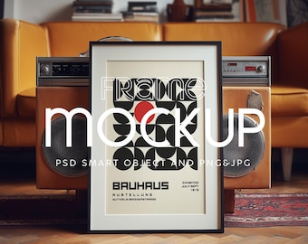 May include: A framed Bauhaus poster with a black frame, featuring a geometric design in black and white with a red circle. The poster is displayed in a room with a vintage stereo and a yellow sofa.