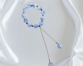 May include: A bracelet made of glass beads and stainless steel. The bracelet is light blue and silver, with a circumference of 5.1-5.5 inches. The text on the image says the material is glass beads and stainless steel.