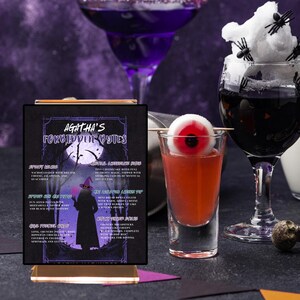 May include: Two printable signs with a Halloween theme. The signs are black with white text and feature a witch and a moon. The text on the signs reads "Agatha's Favorite Potions" and "Agatha's Potions Lab".