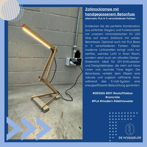 May include: A unique desk lamp made from a folding ruler and concrete base. The lamp features a bright LED light strip and is labeled "Zollstocklampe" with text in German. The design is modern and minimalist.