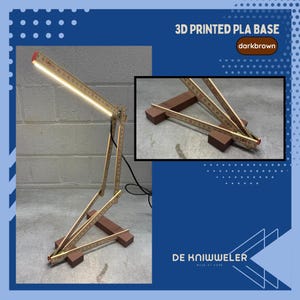 May include: A unique desk lamp made from folding rulers and a 3D-printed dark brown base. The lamp features a bright LED light and a creative design. The text "3D PRINTED PLA BASE" and "darkbrown" are visible.