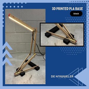May include: A unique desk lamp made from wooden folding rulers, with a bright LED light. The lamp is supported by a black 3D printed PLA base. The text "3D PRINTED PLA BASE" and "black" are visible.