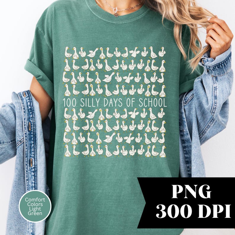 May include: A light green t-shirt with a repeating pattern of white geese and the text "100 Silly Days of School". The shirt is made of Comfort Colors fabric.