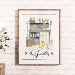 May include: Watercolor print of a garden scene with a wooden frame. The artwork depicts a potting table with gardening tools, plants, and yellow rain boots. The text "Le Jardin" is written in cursive below the scene.