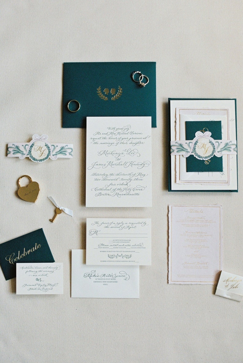 luxury foil and letterpress calligraphy wedding invitations with monogram, watercolor belly band, and handmade paper by invitation designer Robyn Love Steele