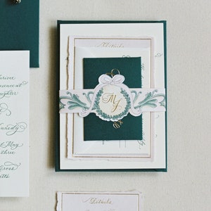 luxury foil and letterpress calligraphy wedding invitations with monogram, watercolor belly band, and handmade paper