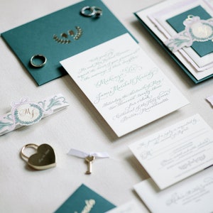 luxury foil and letterpress calligraphy wedding invitations with monogram, watercolor belly band, and handmade paper