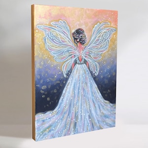 May include: A painting of a fairy with large, intricate wings. The fairy is wearing a long, flowing white dress and has a crown of flowers in her hair. The background is a gradient of pink, purple, and blue with gold glitter.