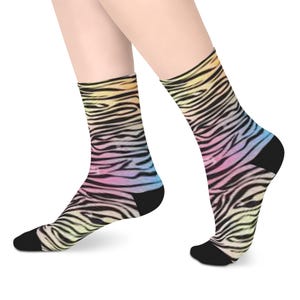 May include: A pair of black socks with a rainbow zebra print. The socks are made of a soft, comfortable material and are perfect for everyday wear.