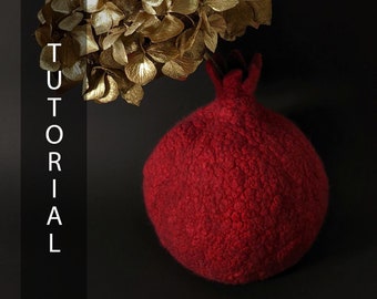 May include: A handcrafted, red pomegranate-shaped decorative item with a textured surface. The word "TUTORIAL" is vertically displayed in white letters on the left side of the image. Gold-colored dried flowers are in the background.