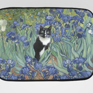 May include: Black and white cat in a field of blue irises, a laptop sleeve featuring a painting by Vincent van Gogh. The artwork has a black border and a zipper closure.