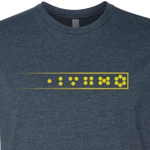 May include: A dark blue t-shirt with a yellow graphic of the word "VINO" in a stylized font.