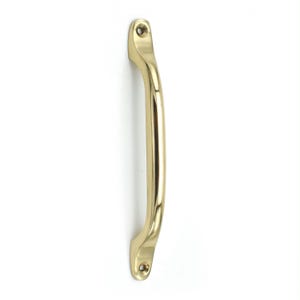 May include: A polished brass door handle with a smooth, curved design. The handle features two flat mounting ends, each with a single circular screw hole, positioned at the top and bottom for secure attachment to a door or cabinet surface.