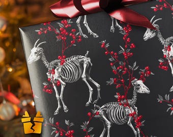 May include: Black gift wrap featuring a repeating pattern of goat skeletons with red berry branches. A large, dark red bow adorns the wrapped gift. The background is blurred, suggesting a Christmas tree.