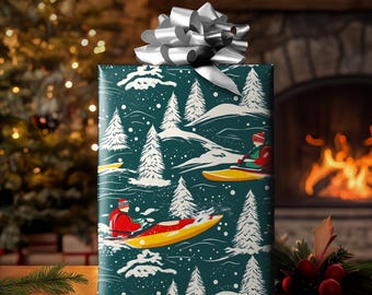 May include: A wrapped gift with a silver bow. The wrapping paper features a winter scene with kayakers, snow-covered hills, and evergreen trees in white against a teal background. The gift is on a wooden surface.