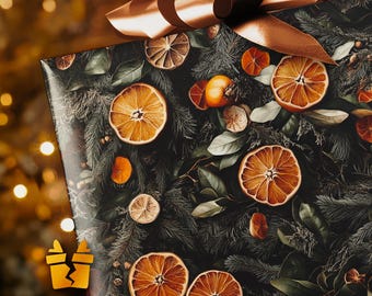 May include: A wrapped gift with a dark background featuring dried orange slices, green leaves, and pine needles. A large copper-coloured bow sits on top. The gift wrap has a festive, natural theme.