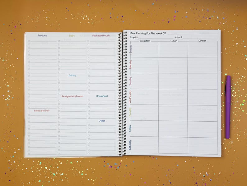 a planner with a pen on top of it