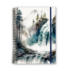 May include: A spiral bound notebook with a watercolor illustration of a waterfall cascading down a mountainside. The cover features a blue ribbon bookmark.