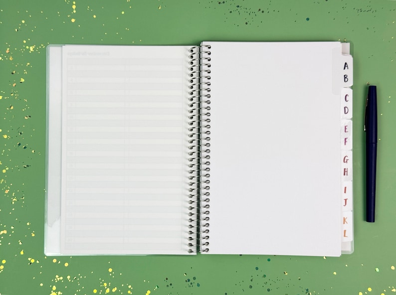 a notebook with a pen on top of it