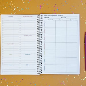 a planner with a pen on top of it