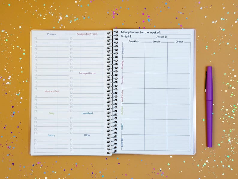 a planner with a pen on top of it
