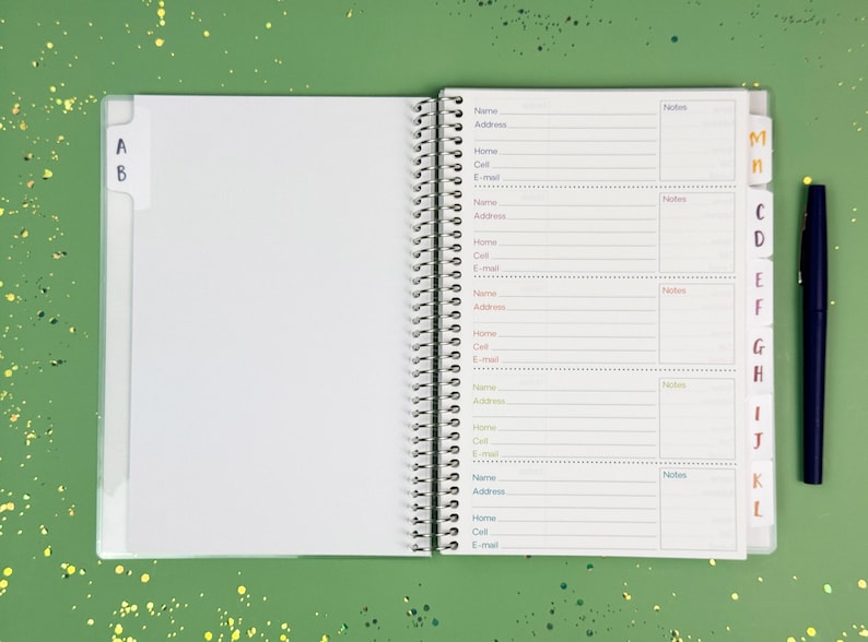 a note book with a pen on top of it
