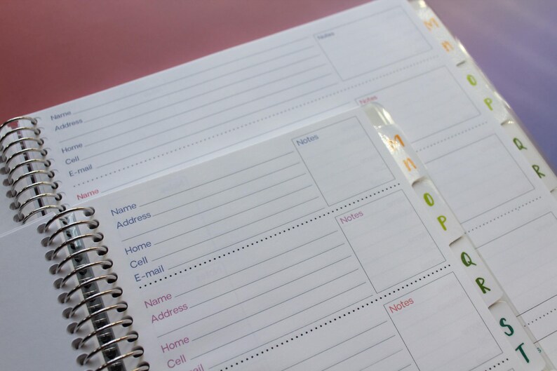 a spiral-bound notebook with a page for contact information and a separate page for notes. The notebook appears to be organized and ready for use.