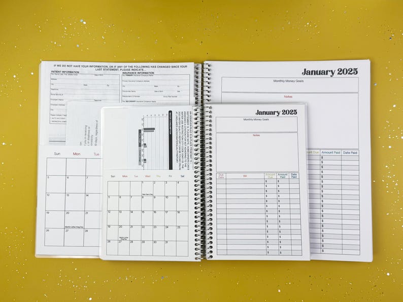 a spiral bound planner is open on a yellow surface