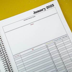 a spiral bound planner is open on a table