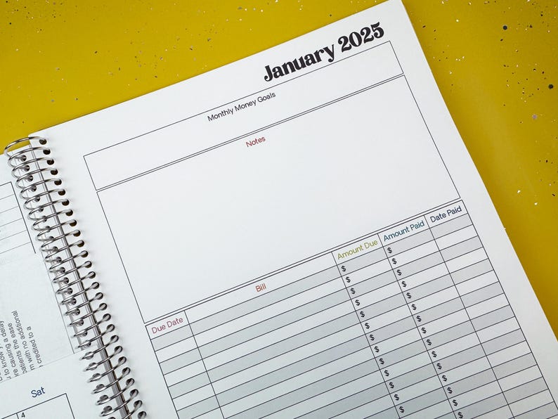 a spiral bound planner is open on a table
