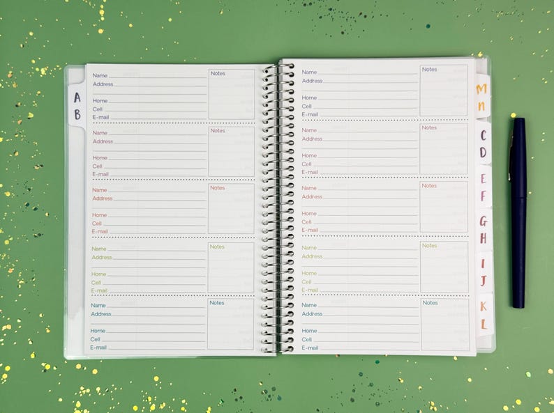 a planner with a pen on top of it