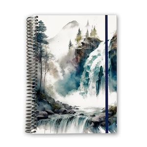May include: A spiral bound notebook with a watercolor illustration of a waterfall cascading down a mountainside. The cover features a blue ribbon bookmark.