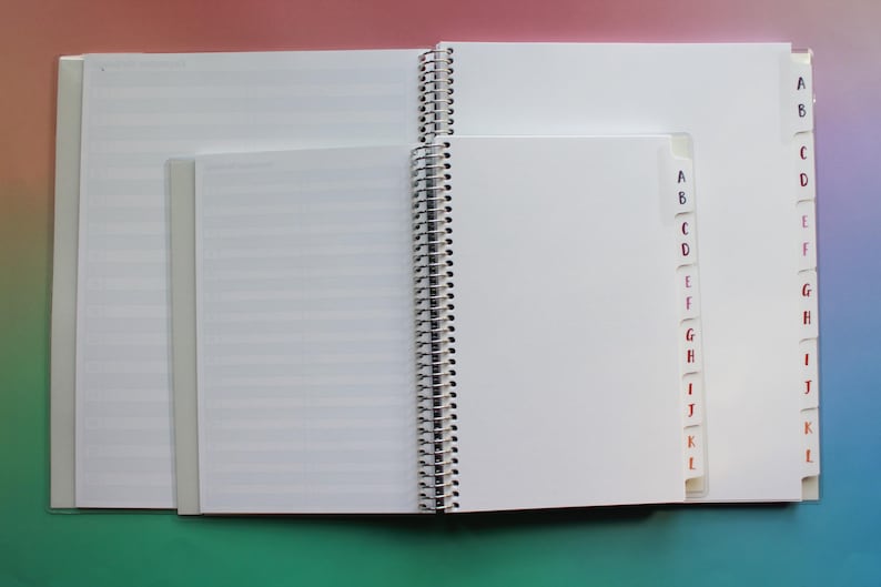 an open spiral-bound notebook with blank pages, placed on a colorful background.