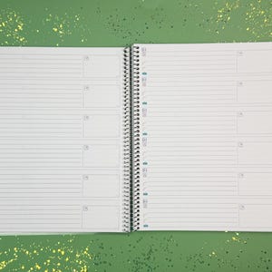 a notebook with a pen on top of it