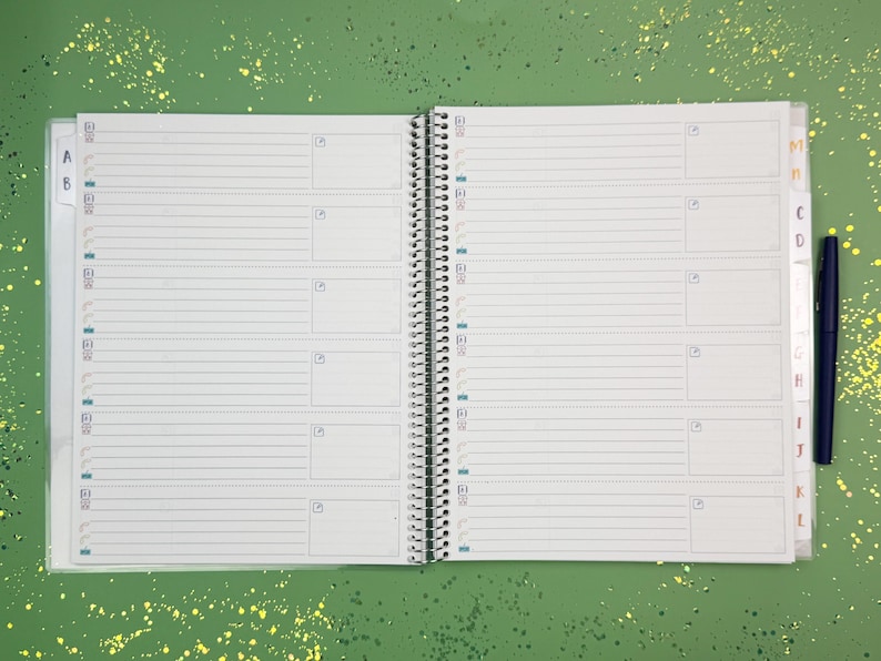 a notebook with a pen on top of it