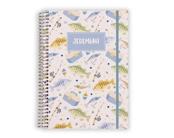 May include: A spiral-bound notebook featuring a repeating pattern of fishing gear including yellow and green fish, blue tackle boxes, fishing rods, and hooks on a white background. A central blue rectangular label displays the name JEREMIAH.